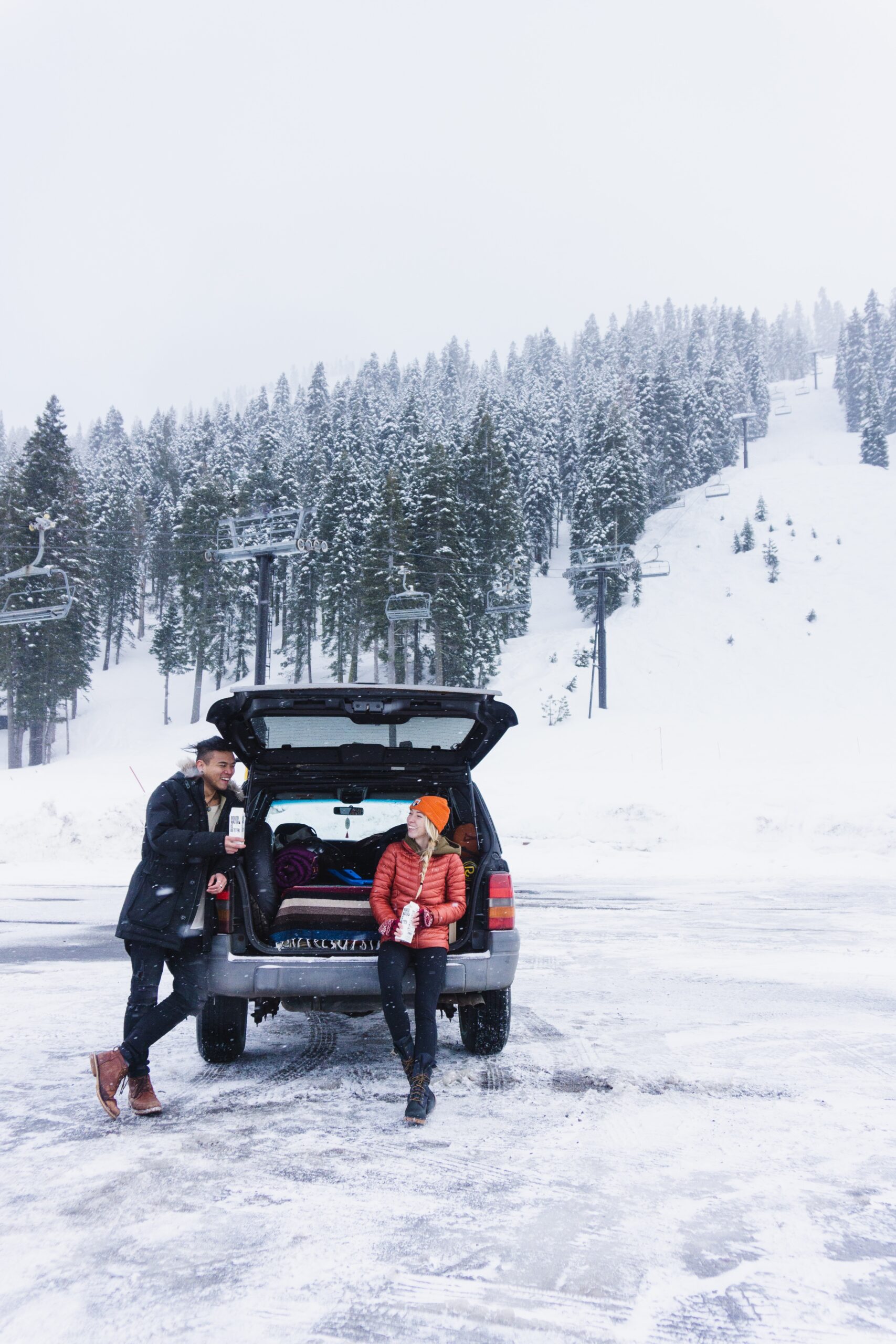 woman with man standing near SUV